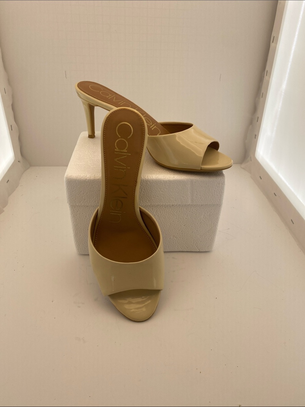 Calvin Klein Patent Leather Open-Toe Slide Mules in Cream